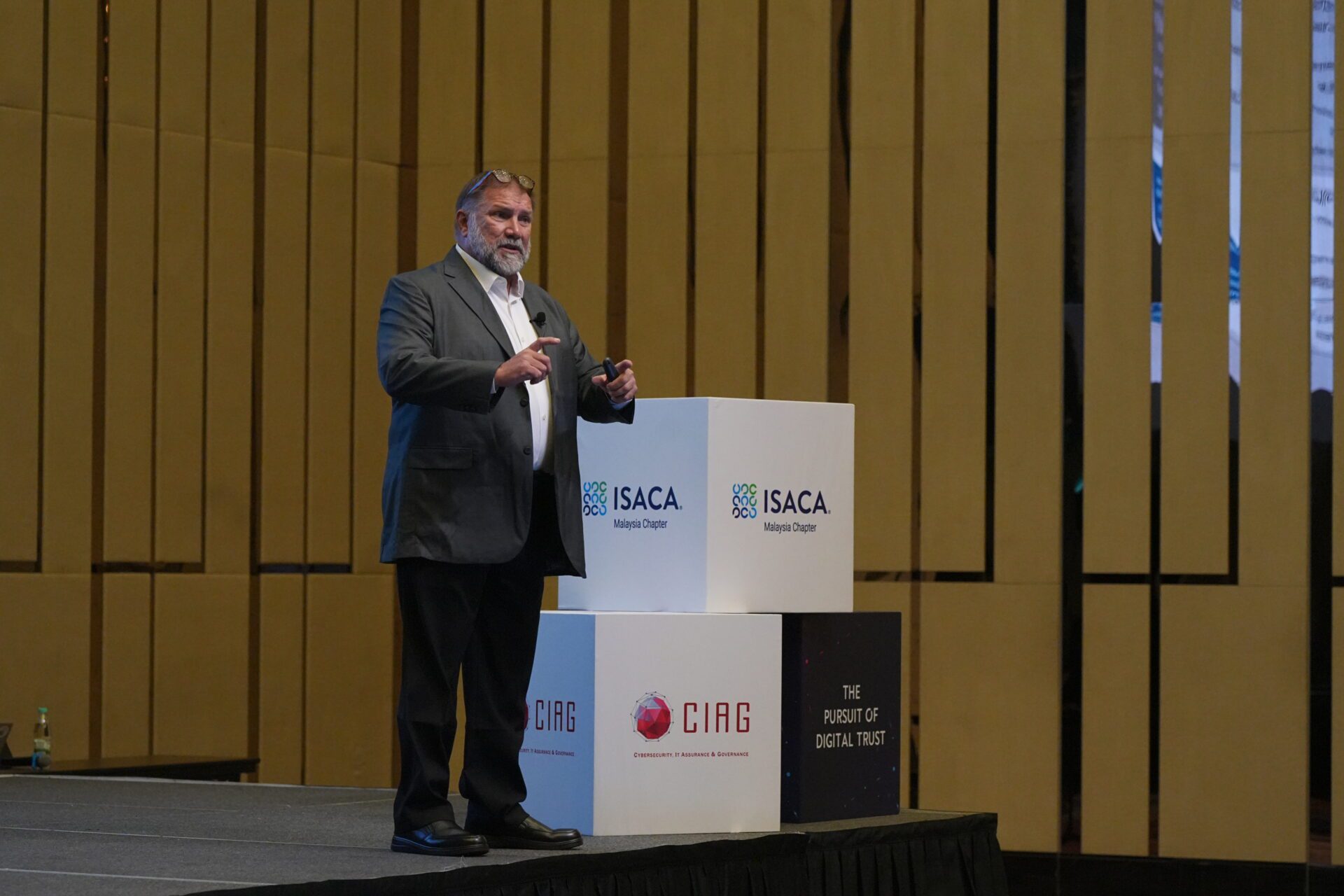 Mark speaking on stage executive speaker presenting on governance and risk strategy at industry event